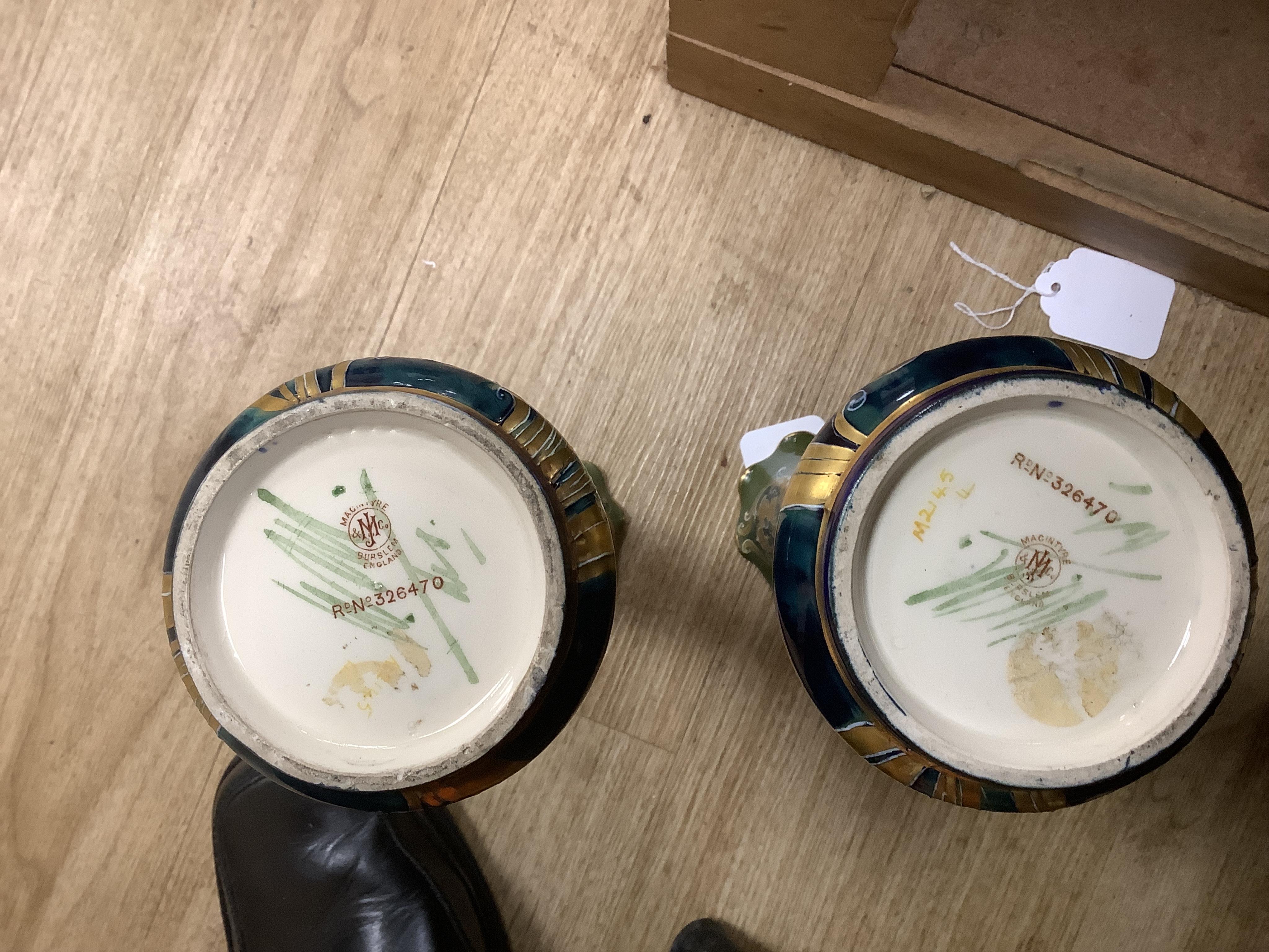 A pair of early 20th century Moorcroft MacIntrye Florian green and gold vases, signed and stamped to the bases, 29cm high